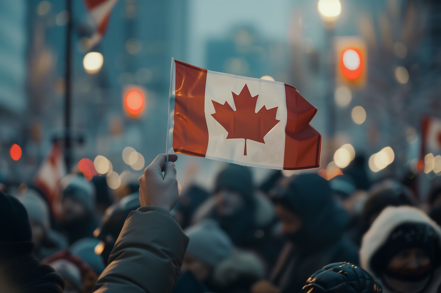 Canadian flag projected on a downtown building at night